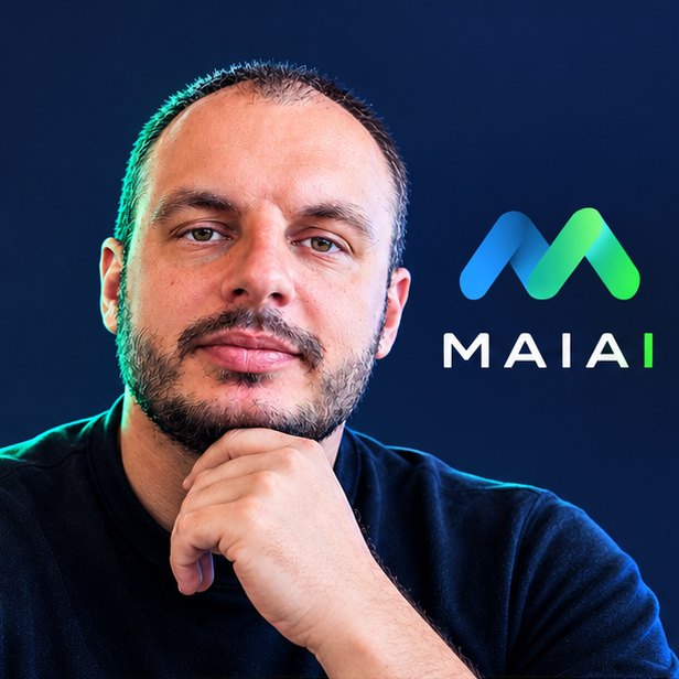 Кирилл, основатель MAIAI, рядом с логотипом